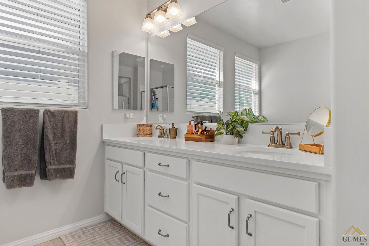 Undisclosed Address Bakersfield, CA 93311 - Photo 25 of 37 a bathroom with a sink double vanity and a mirror