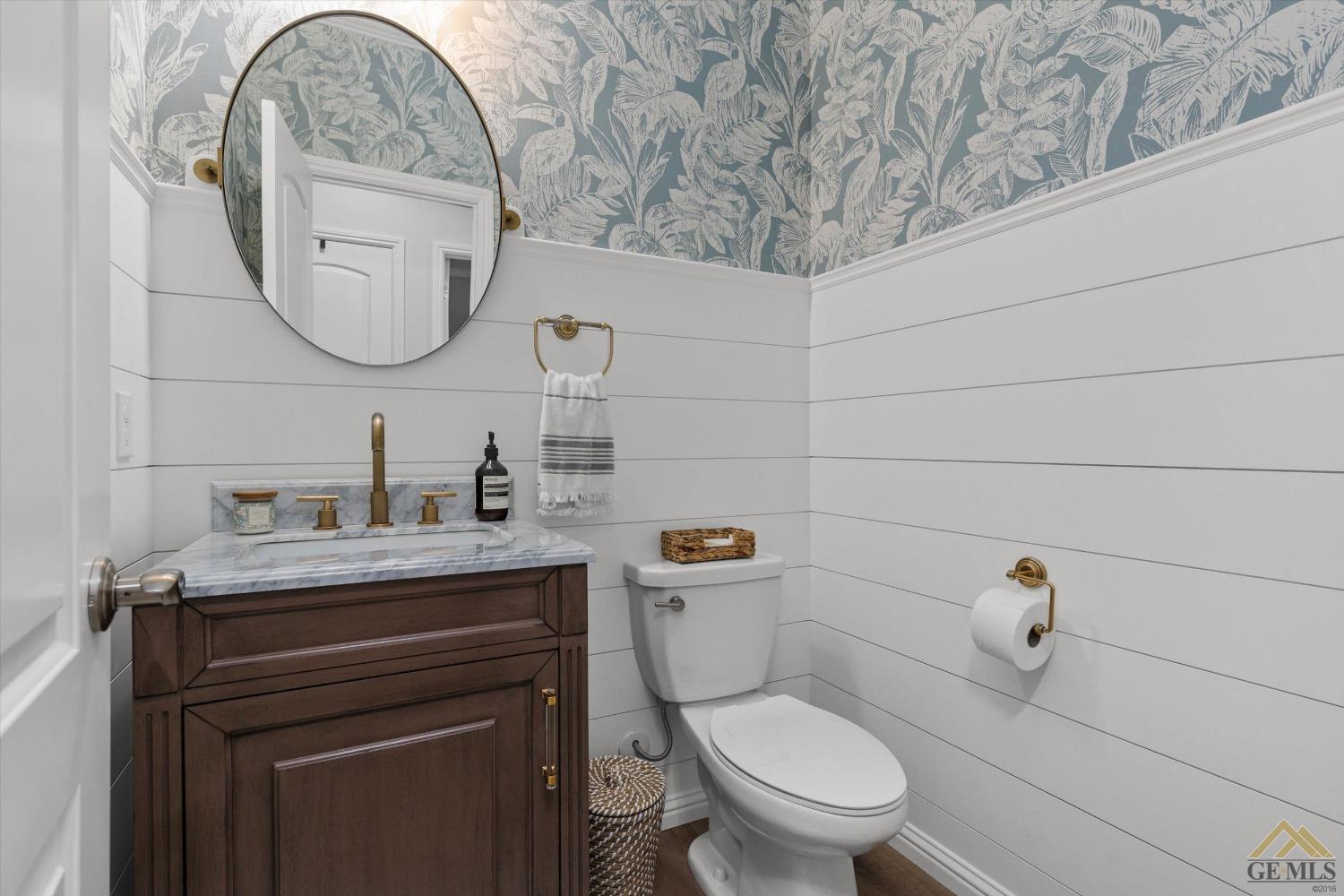 Undisclosed Address Bakersfield, CA 93311 - Photo 30 of 37 a bathroom with a toilet a sink and mirror