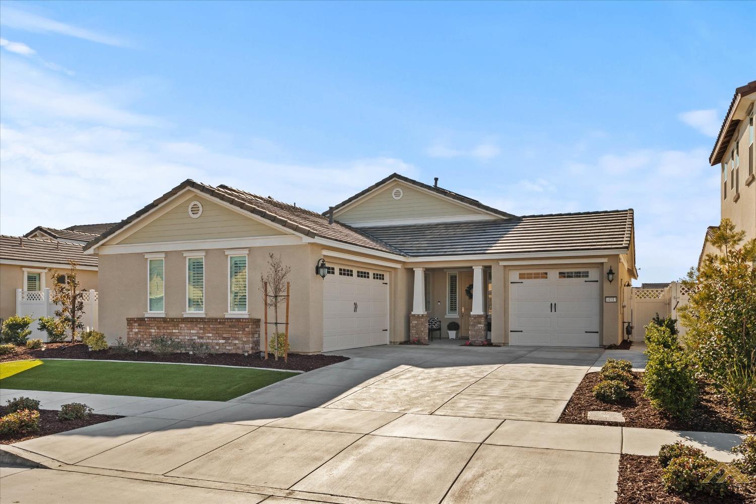 Undisclosed Address Bakersfield, CA 93311 - Photo 3 of 37 a front view of a house with a yard and garage