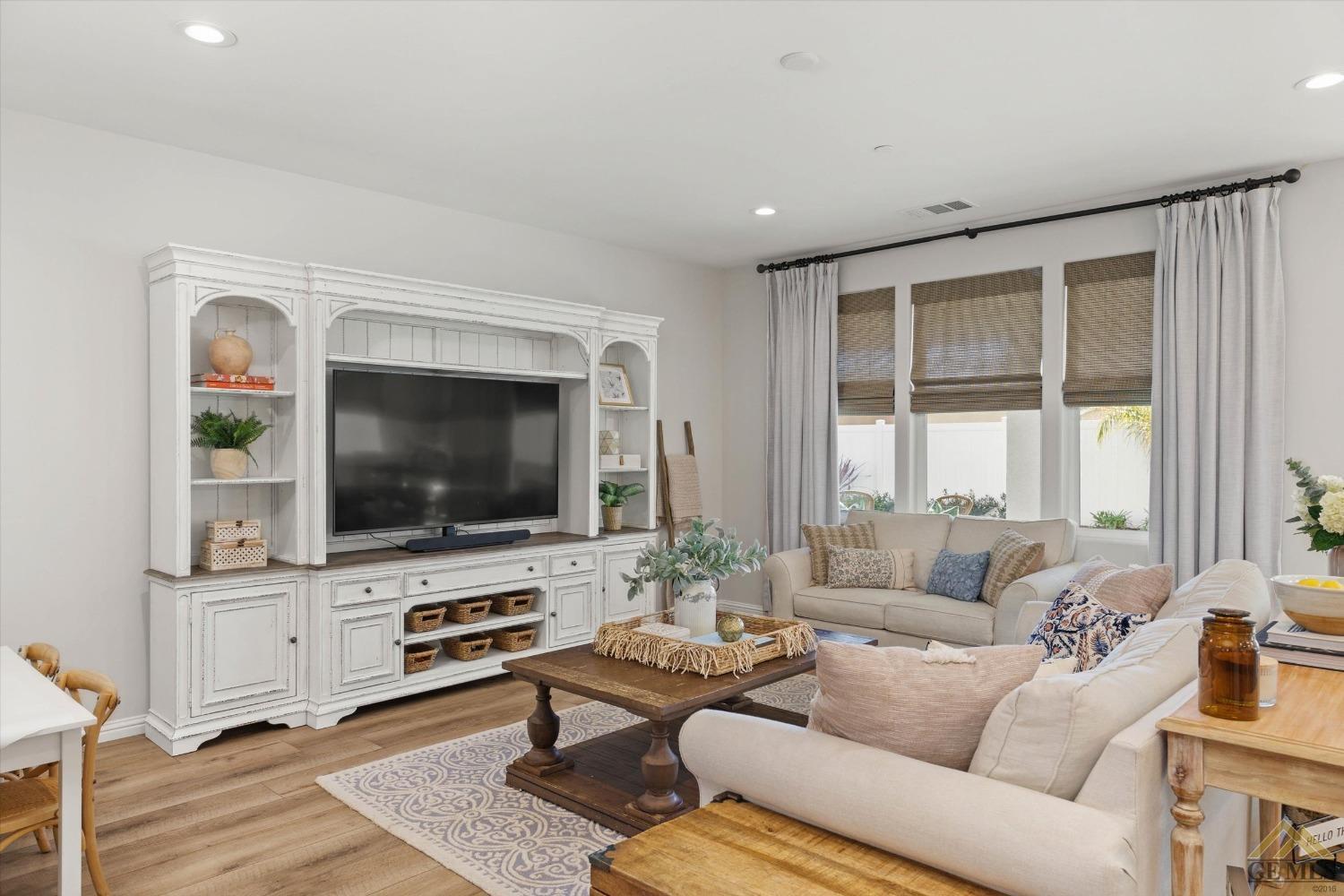 Undisclosed Address Bakersfield, CA 93311 - Photo 8 of 37 a living room with furniture and a flat screen tv