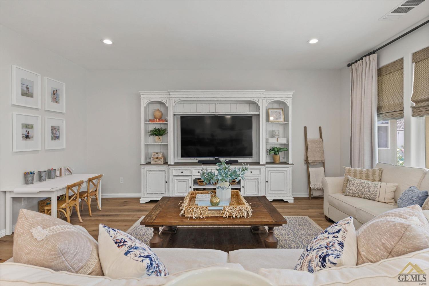 Undisclosed Address Bakersfield, CA 93311 - Photo 9 of 37 a living room with furniture and a flat screen tv