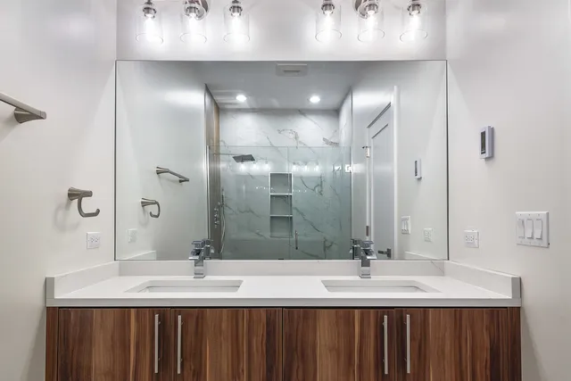 a bathroom with a double vanity sink and a mirror