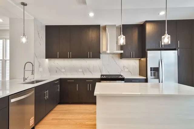 a kitchen with a sink a counter space and cabinets