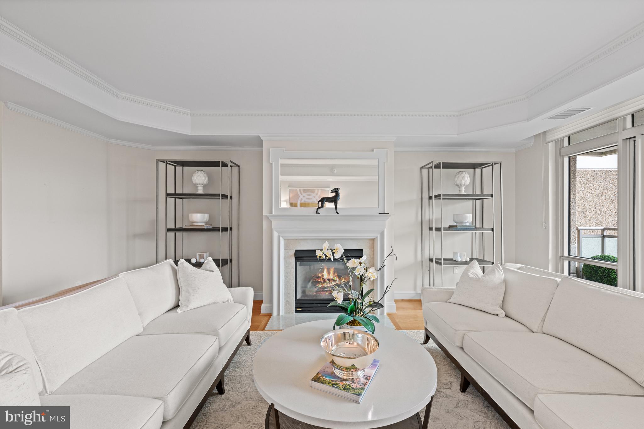5630 Wisconsin Avenue, Unit 903 Chevy Chase, MD 20815 - Photo 12 of 50 a living room with furniture and a fireplace