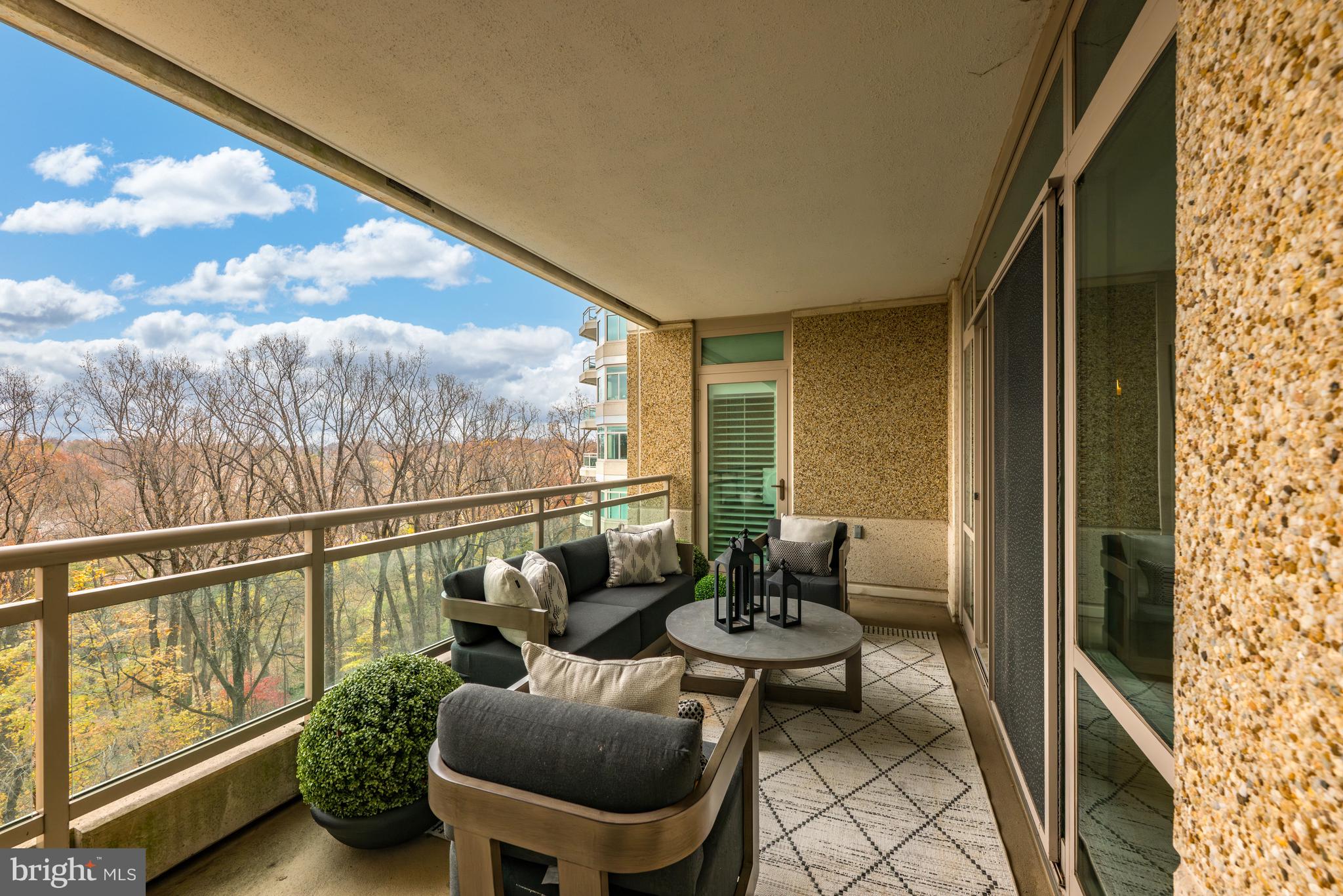 5630 Wisconsin Avenue, Unit 903 Chevy Chase, MD 20815 - Photo 13 of 50 a balcony with chairs and with potted plants