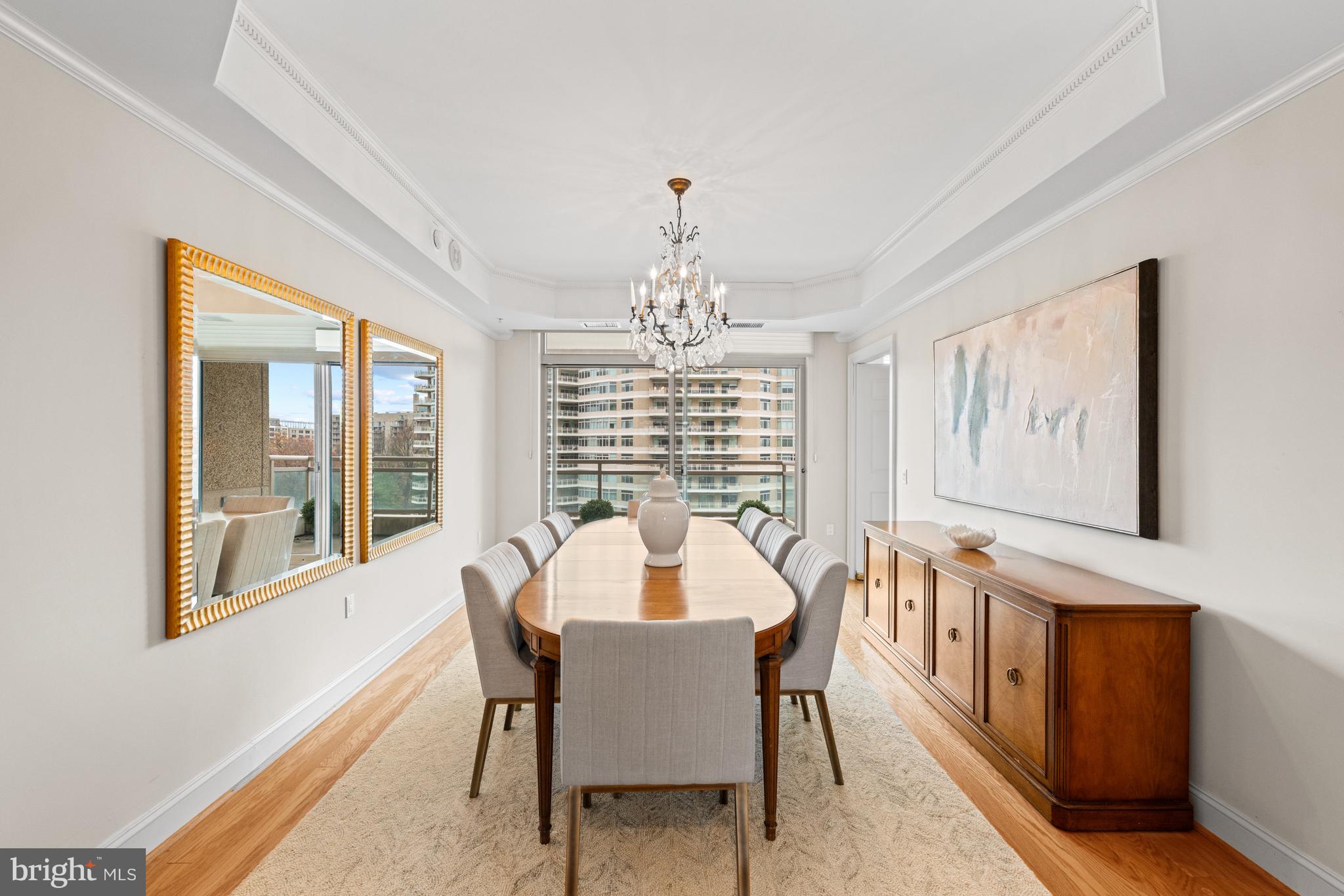 5630 Wisconsin Avenue, Unit 903 Chevy Chase, MD 20815 - Photo 16 of 50 a dining room with furniture a chandelier and wooden floor