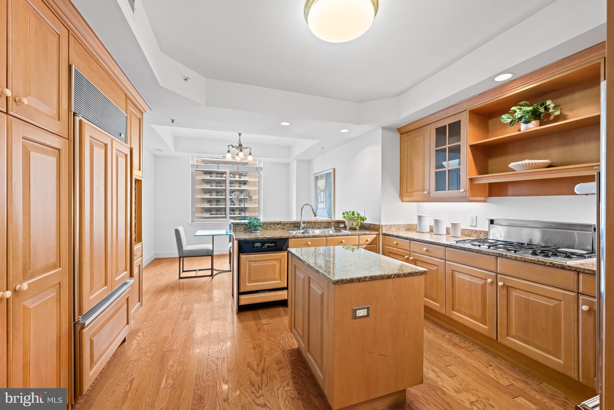 5630 Wisconsin Avenue, Unit 903 Chevy Chase, MD 20815 - Photo 17 of 50 a kitchen with stainless steel appliances granite countertop sink stove top oven and cabinets
