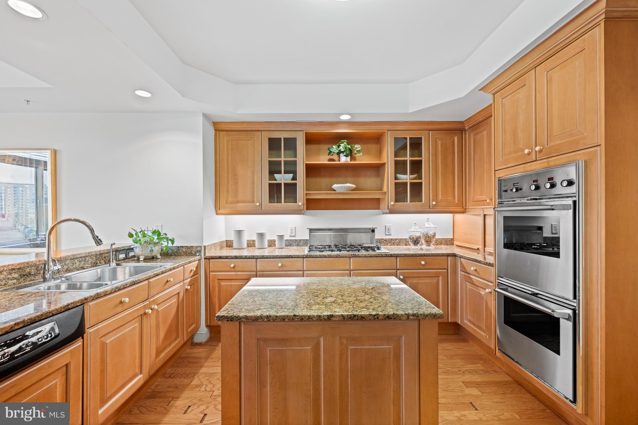 5630 Wisconsin Avenue, Unit 903 Chevy Chase, MD 20815 - Photo 18 of 50 a kitchen with a stove sink and cabinets