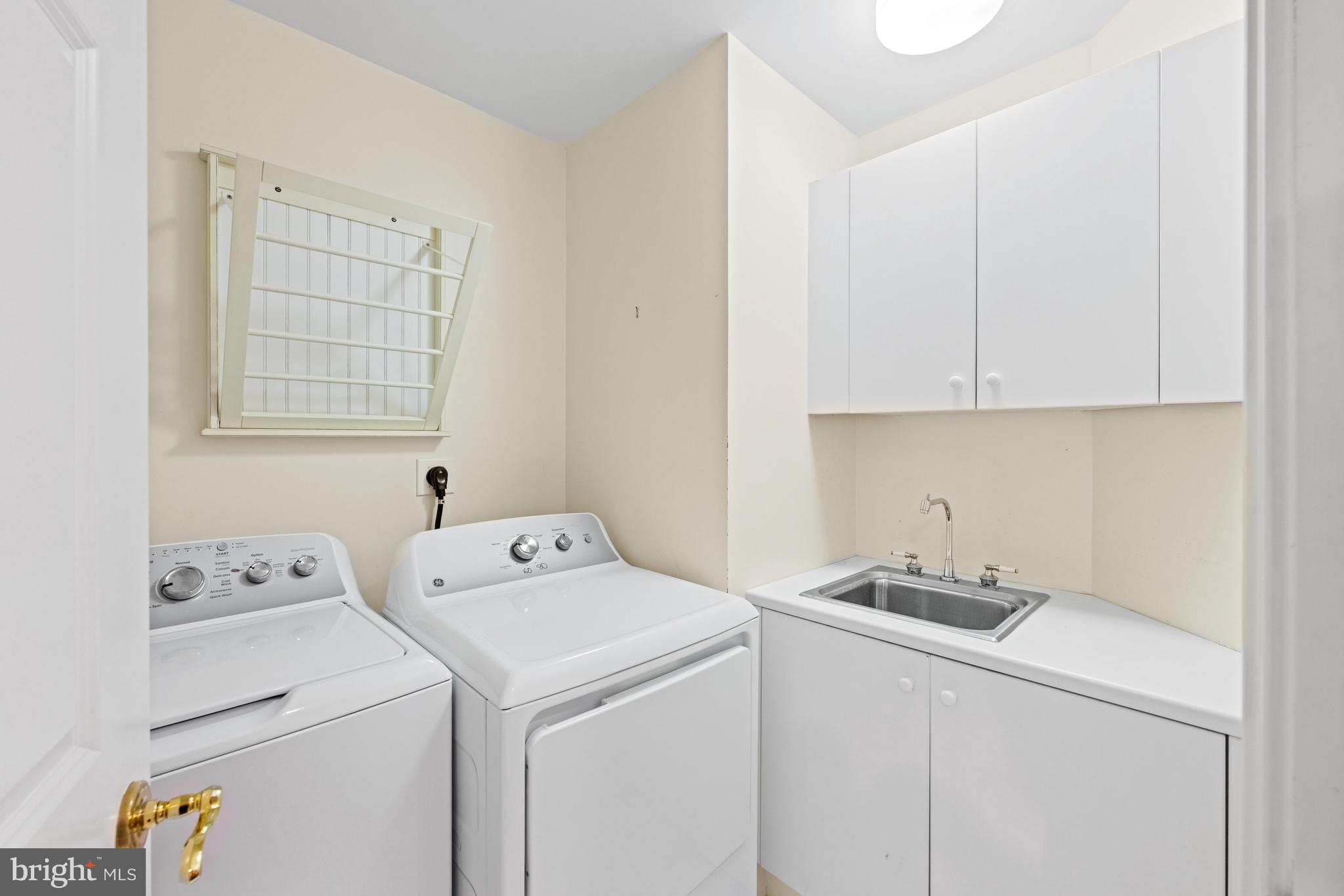 5630 Wisconsin Avenue, Unit 903 Chevy Chase, MD 20815 - Photo 30 of 50 a utility room with dryer and washer
