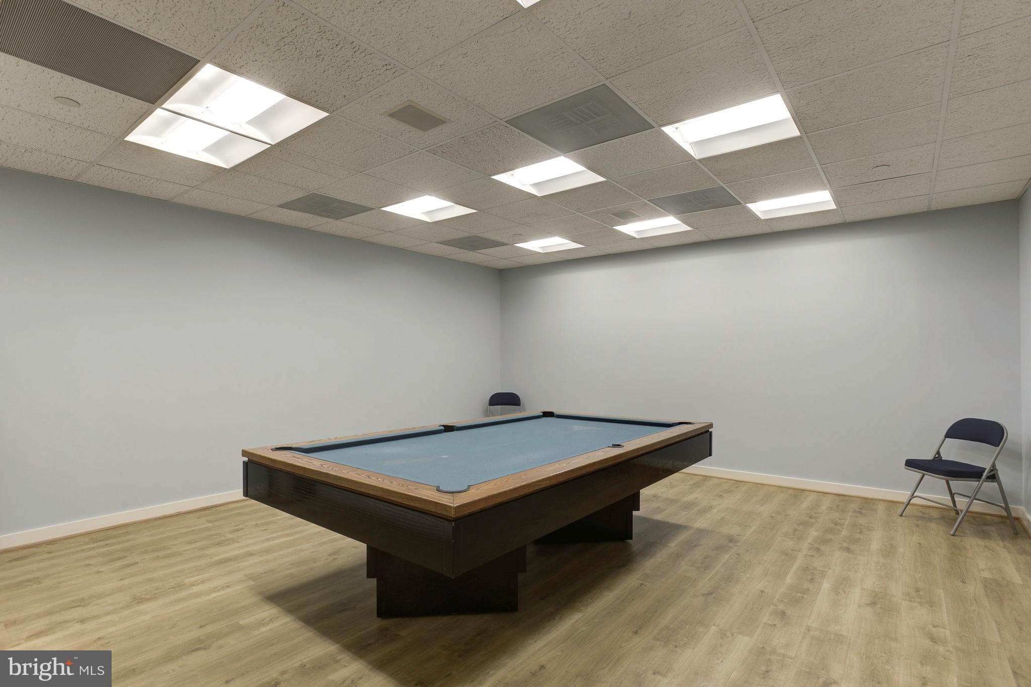 5630 Wisconsin Avenue, Unit 903 Chevy Chase, MD 20815 - Photo 44 of 50 a room with pool table and a chair