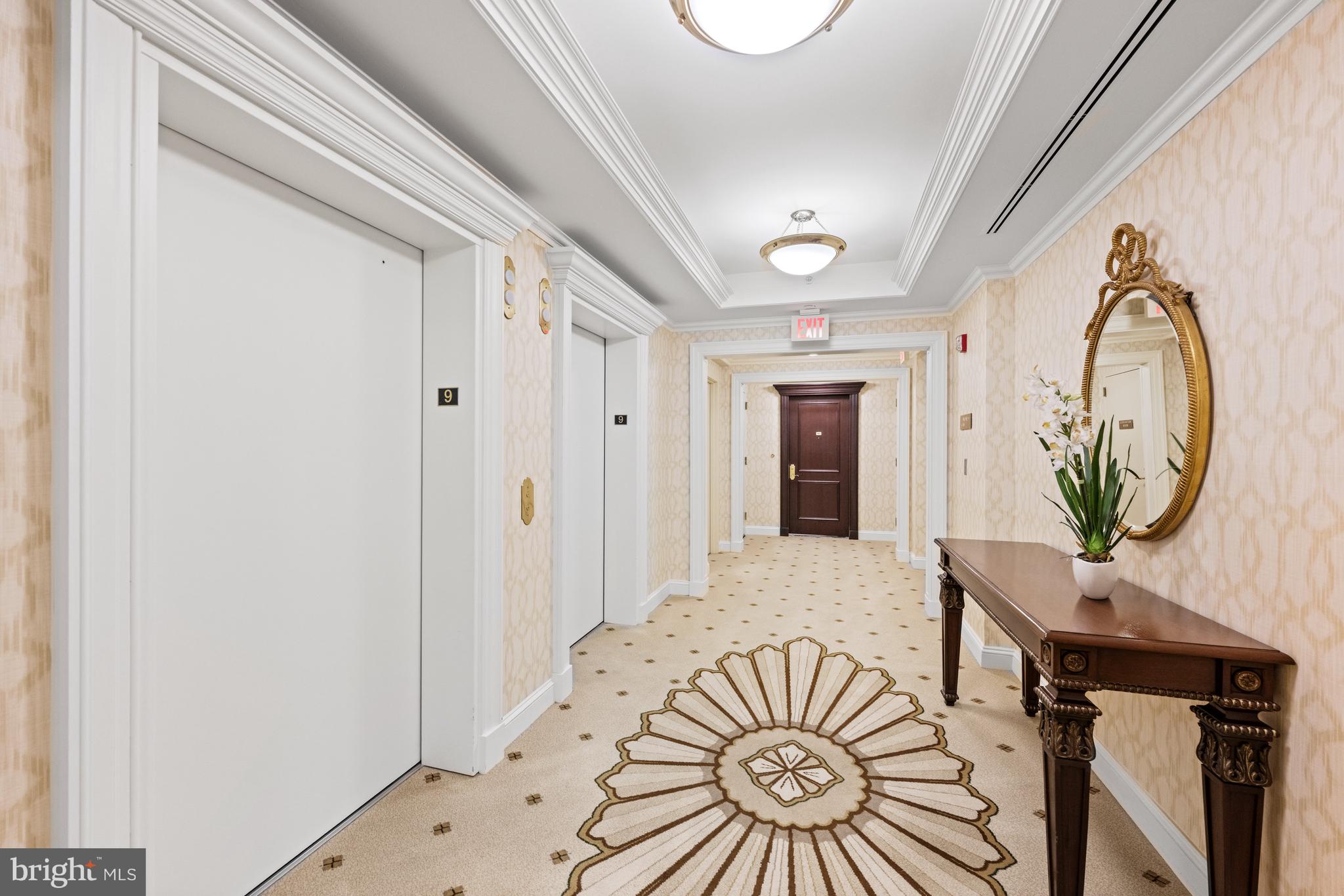 5630 Wisconsin Avenue, Unit 903 Chevy Chase, MD 20815 - Photo 6 of 50 a bedroom with a bed and a chandelier