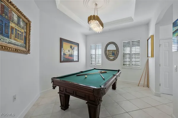 a room with pool table and window