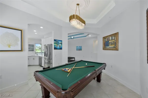 a room with pool table and windows