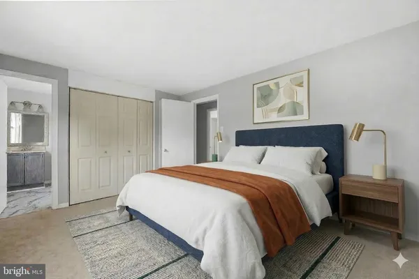 a bedroom with a bed and a painting
