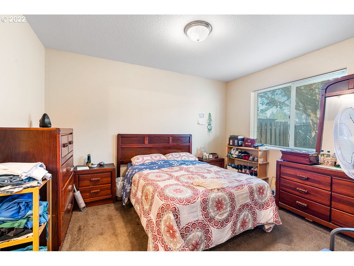 993 Southwest Junction Place Gresham, OR 97080 - Photo 15 of 27 a bedroom with a bed and a dresser
