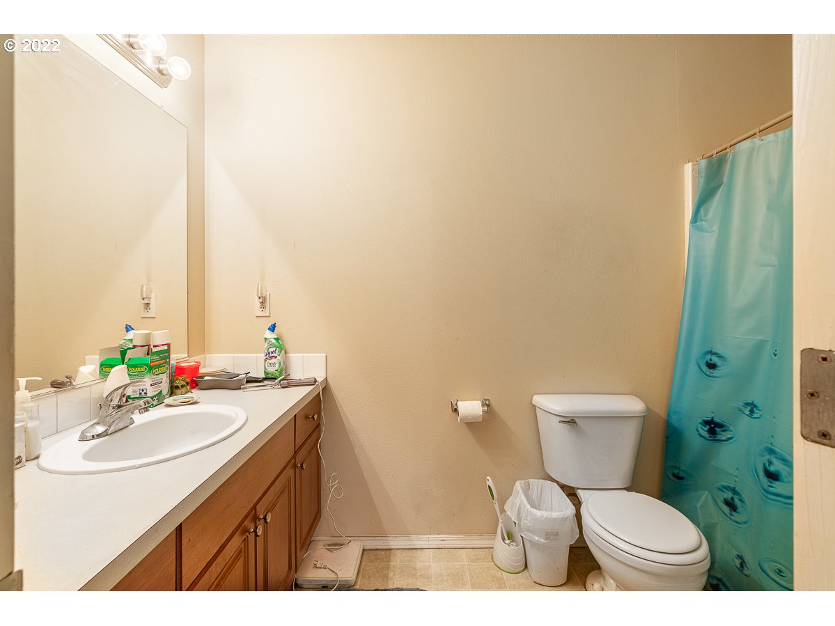 993 Southwest Junction Place Gresham, OR 97080 - Photo 17 of 27 a bathroom with a sink a toilet and mirror