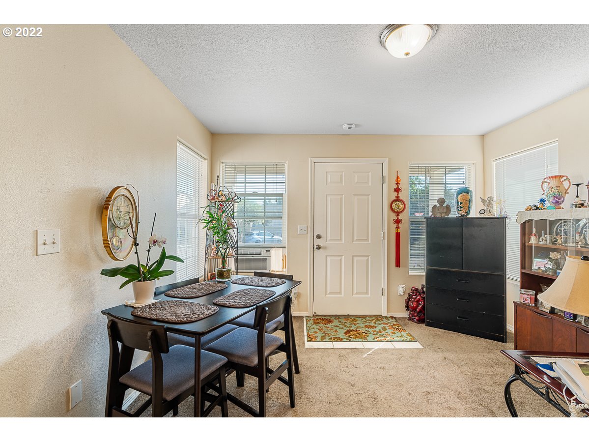 993 Southwest Junction Place Gresham, OR 97080 - Photo 2 of 27 a living room with furniture a window and a table
