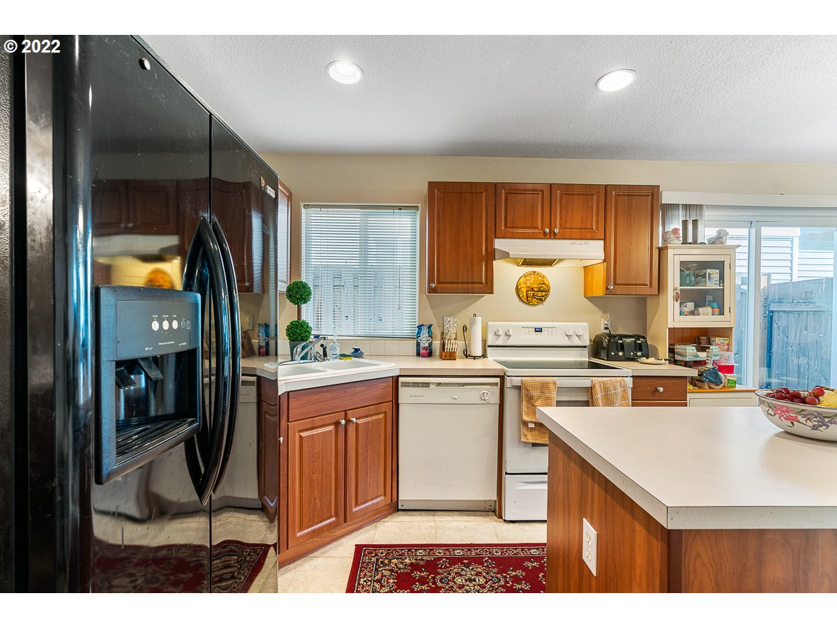 993 Southwest Junction Place Gresham, OR 97080 - Photo 9 of 27 a kitchen with a sink cabinets and window