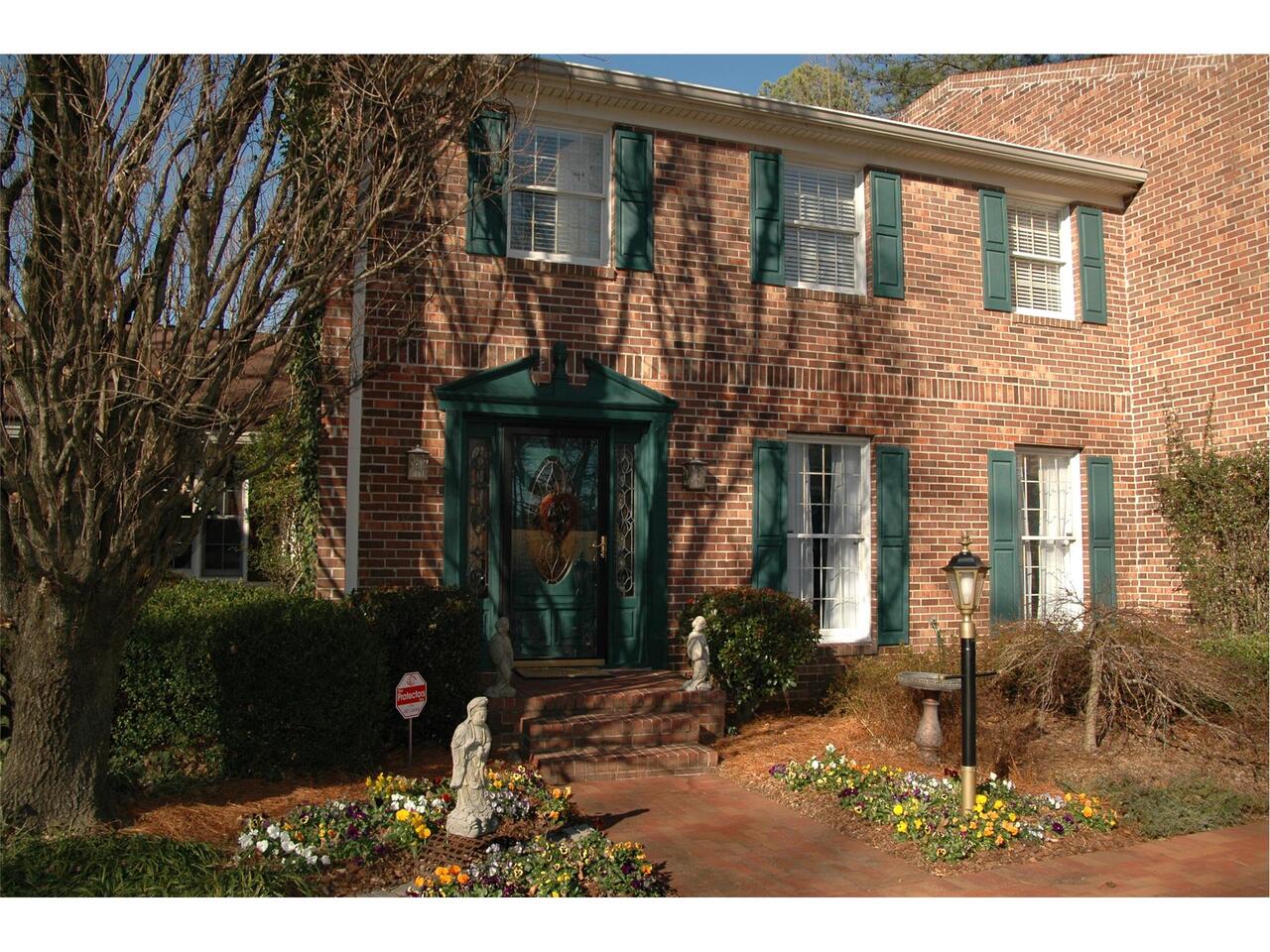 1503 September Chase Decatur, GA 30033 - Photo 1 of 1 a view of a brick house with many windows and a yard