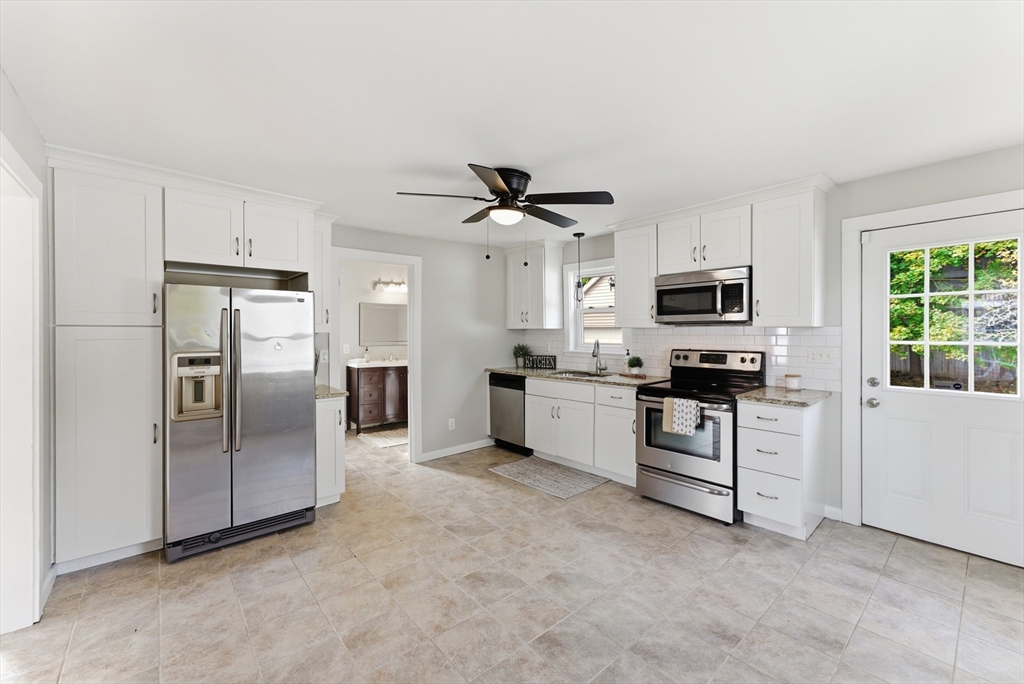 45 Meadow Street Ludlow, MA 01056 - Photo 11 of 32 a kitchen with white cabinets and stainless steel appliances