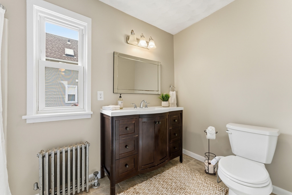 45 Meadow Street Ludlow, MA 01056 - Photo 12 of 32 a bathroom with a toilet a sink and mirror