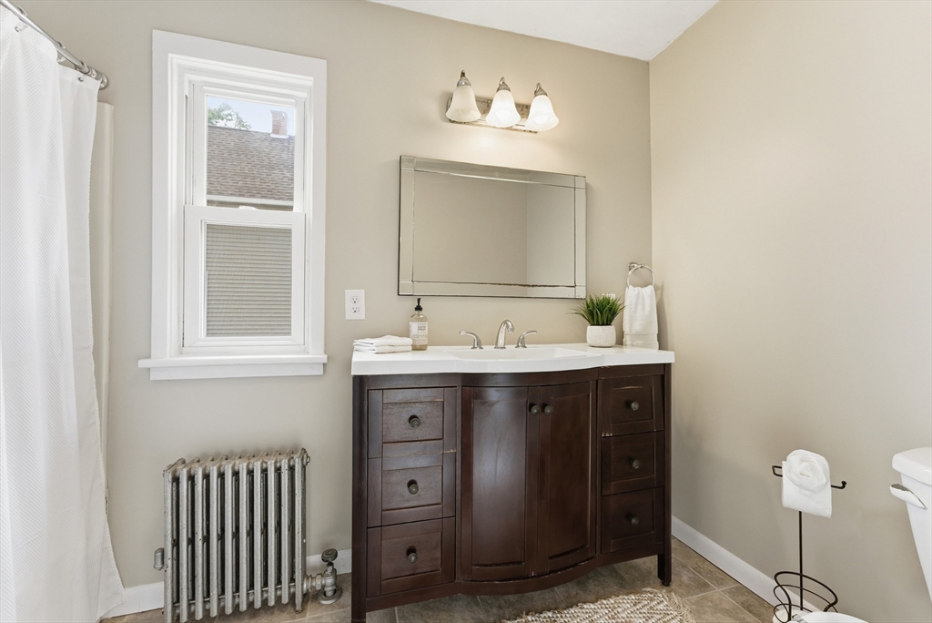 45 Meadow Street Ludlow, MA 01056 - Photo 13 of 32 a bathroom with a sink and a mirror