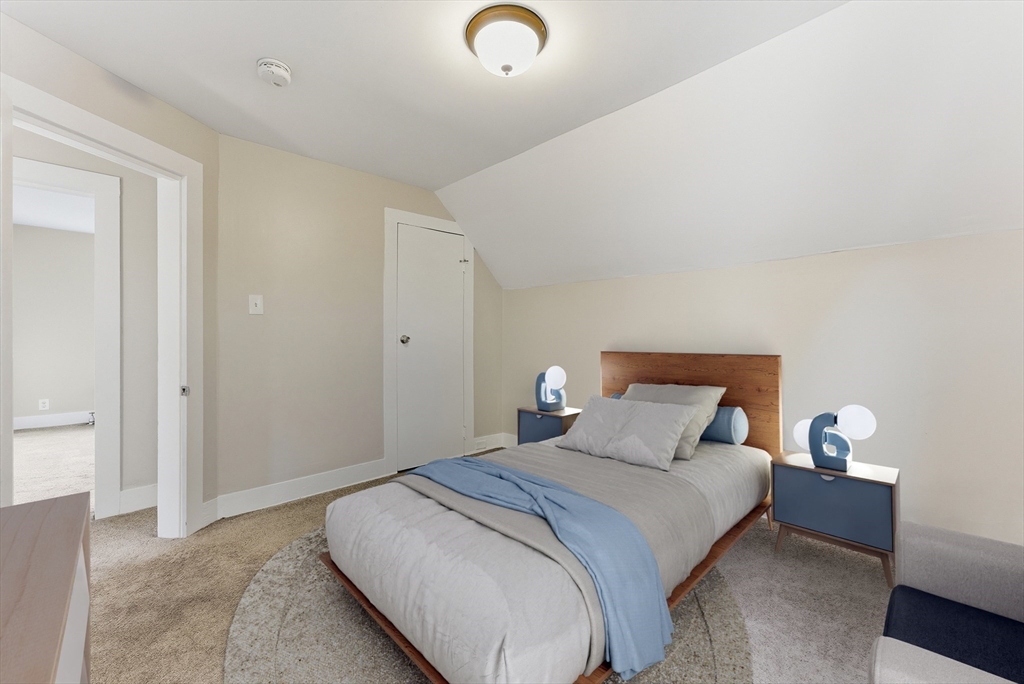 45 Meadow Street Ludlow, MA 01056 - Photo 22 of 32 a bedroom with a bed and a lamp