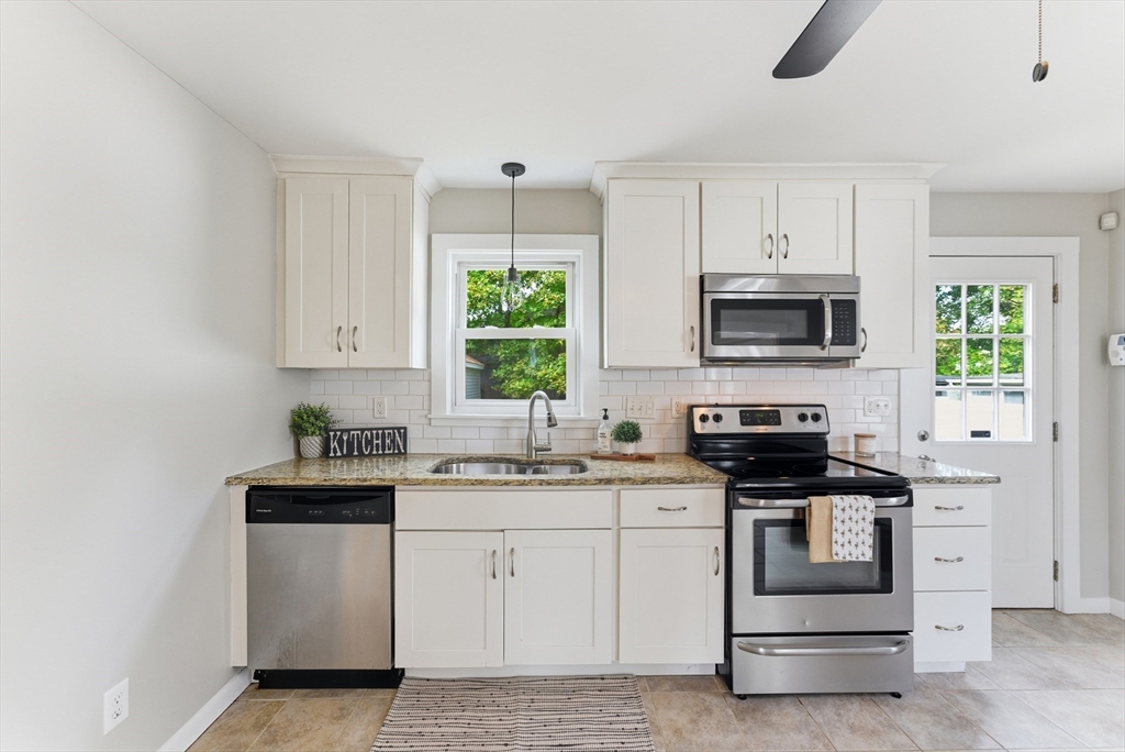 45 Meadow Street Ludlow, MA 01056 - Photo 8 of 32 a kitchen with white cabinets stainless steel appliances and sink