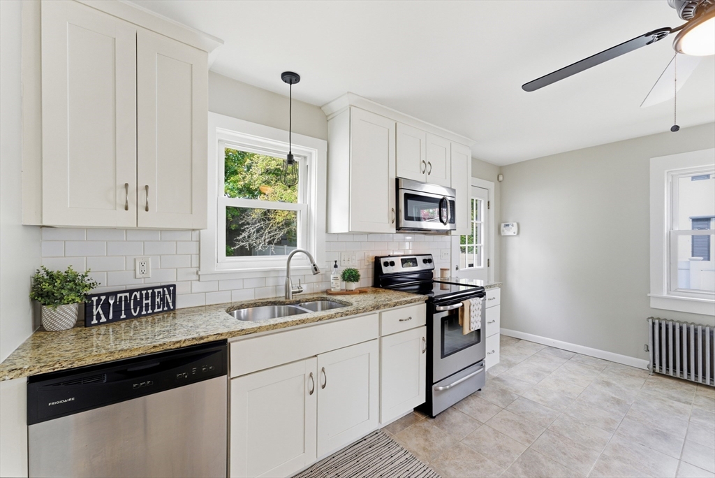 45 Meadow Street Ludlow, MA 01056 - Photo 9 of 32 a kitchen with cabinets appliances a sink and a window
