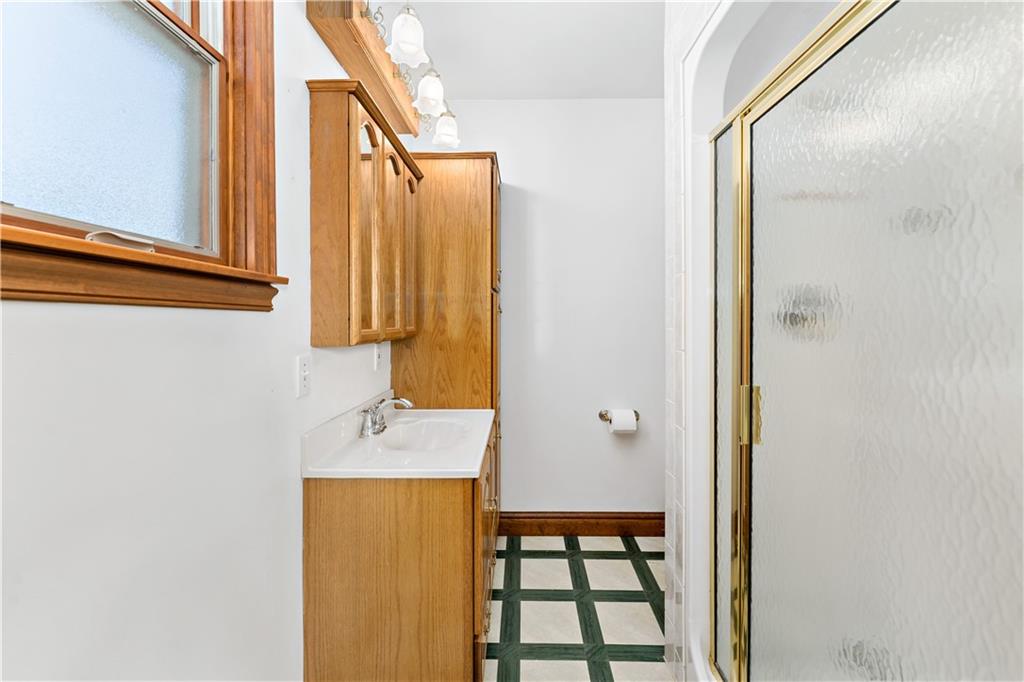 617 Maple Street Coraopolis, PA 15108 - Photo 15 of 38 a bathroom with a sink a mirror and shower