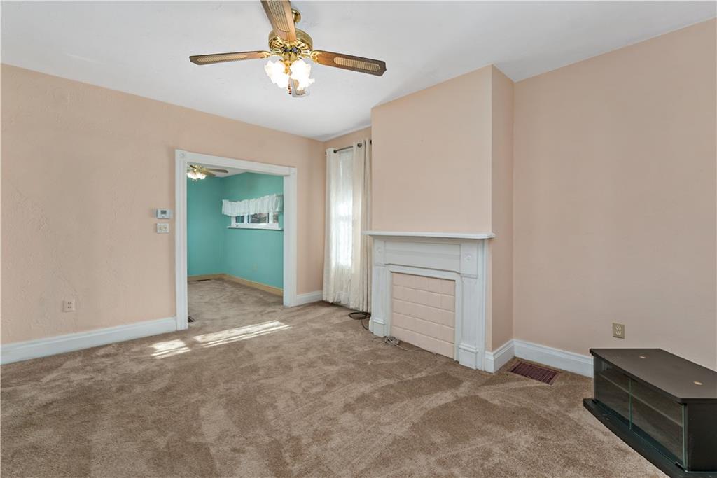 617 Maple Street Coraopolis, PA 15108 - Photo 3 of 38 a view of livingroom with a ceiling fan a fireplace and a window