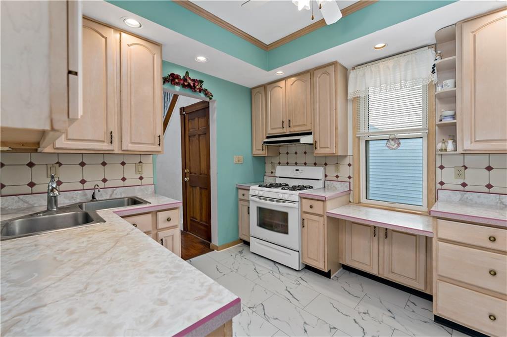 617 Maple Street Coraopolis, PA 15108 - Photo 8 of 38 a kitchen with white cabinets sink and stainless steel appliances