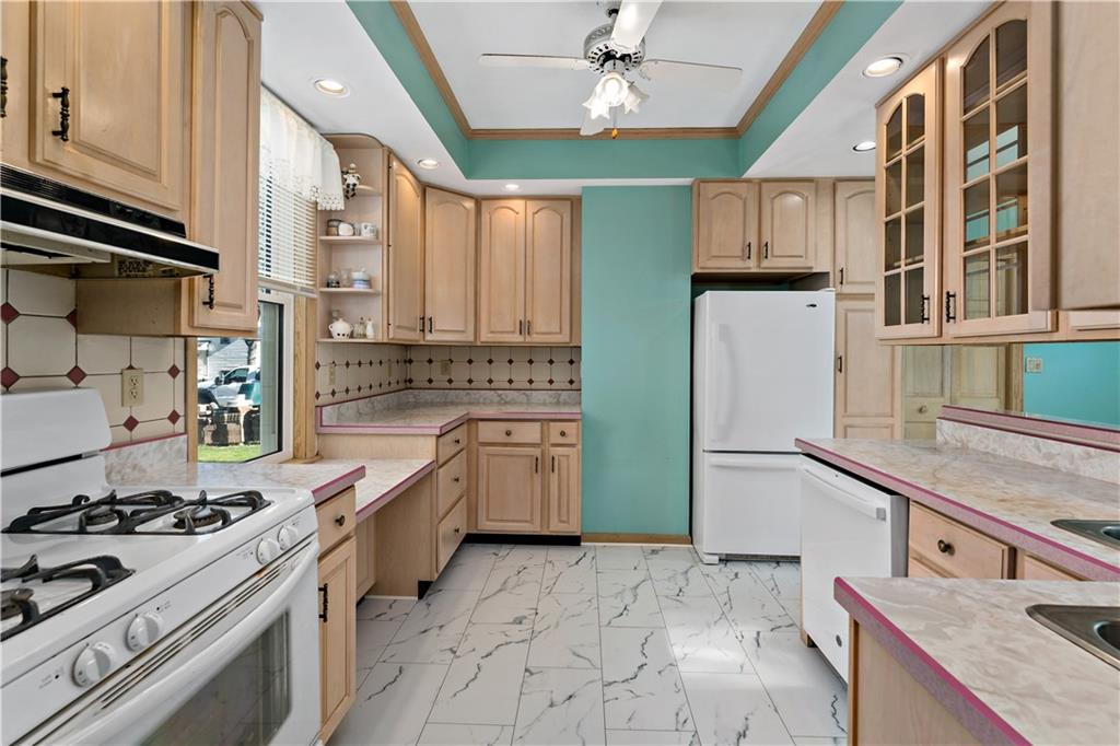 617 Maple Street Coraopolis, PA 15108 - Photo 10 of 38 a kitchen with stainless steel appliances granite countertop a stove and a refrigerator