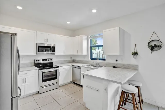 a kitchen with a sink appliances and cabinets