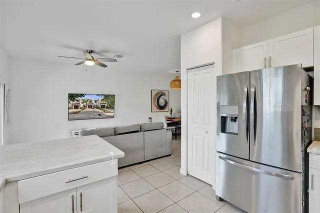 a kitchen with stainless steel appliances a refrigerator sink and microwave