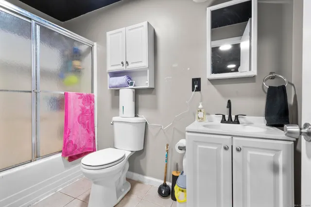 a bathroom with a sink vanity and tub