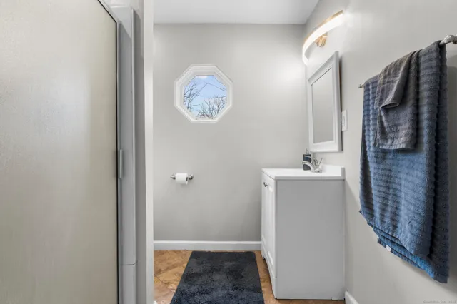 a white toilet sitting next to a bathroom sink