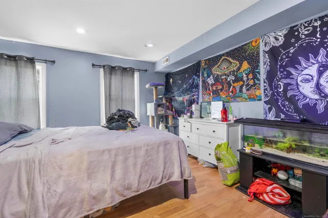 a bedroom with furniture and a large mirror