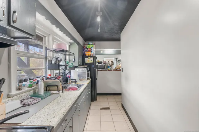 a bed room with a bed and a chair