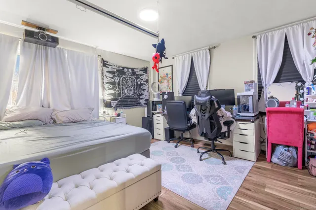 a bedroom with a bed and a potted plant