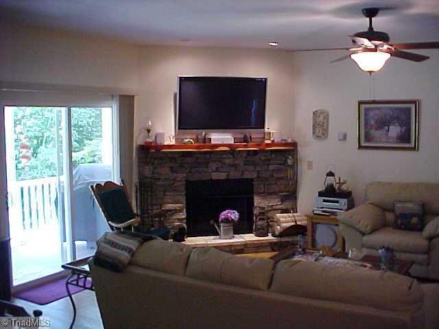 470 Old Mill Road Lowgap, NC 27024 - Photo 2 of 13 Interior Space/Layout. Great room with stone fireplace and tile flooring.
