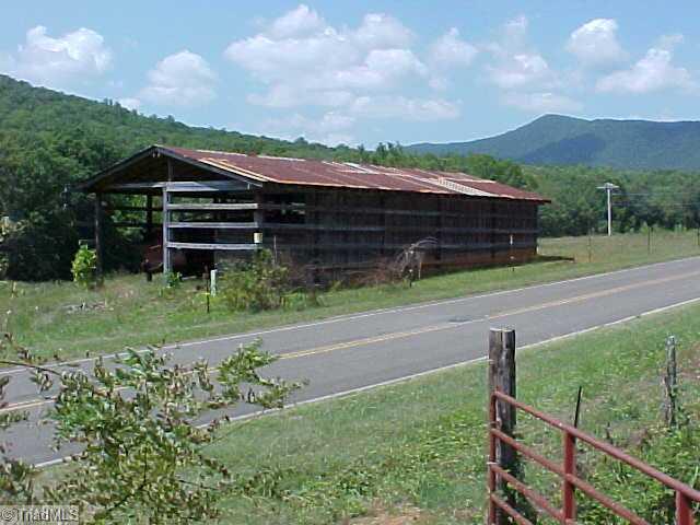470 Old Mill Road Lowgap, NC 27024 - Photo 5 of 13 Stable/Barn. Currently used for storage of equipment. Additional home site is near the pole shown on right.