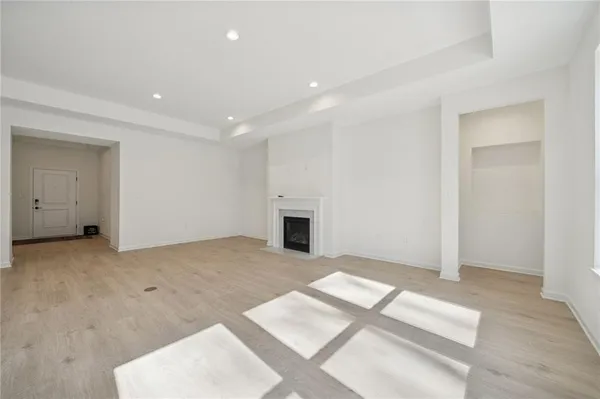 a view of empty room with a fireplace