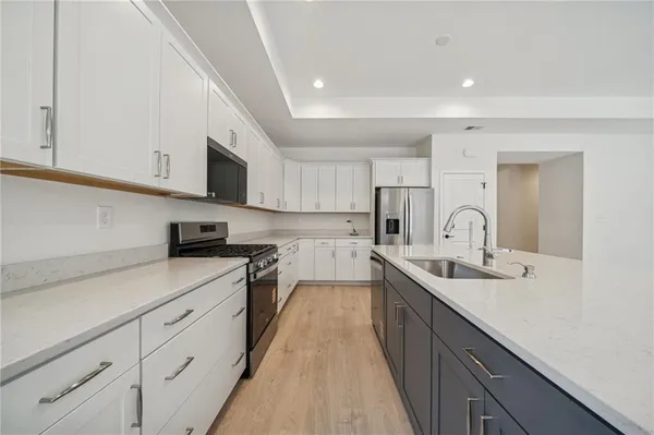 a kitchen with stainless steel appliances granite countertop a sink and stove top oven