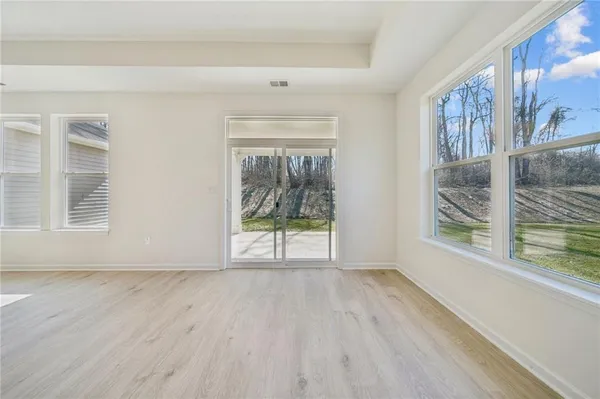 a view of kitchen with kitchen island stainless steel appliances sink cabinets and window