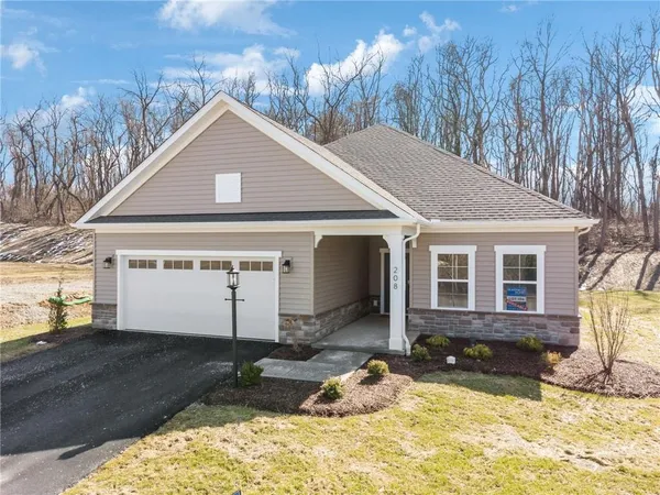 a front view of a house with a yard outdoor seating and yard in the back