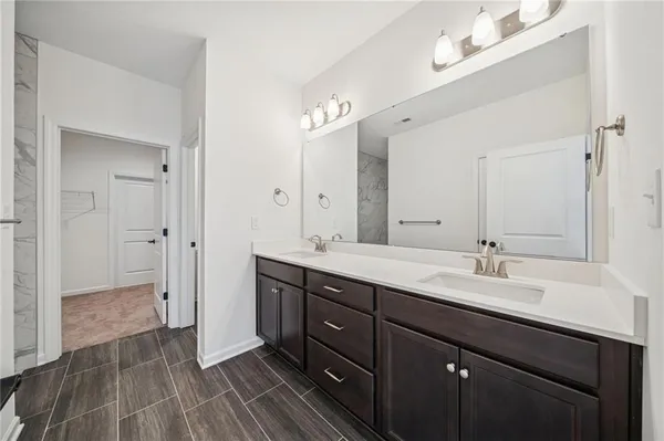 a white toilet sitting next to a white wall