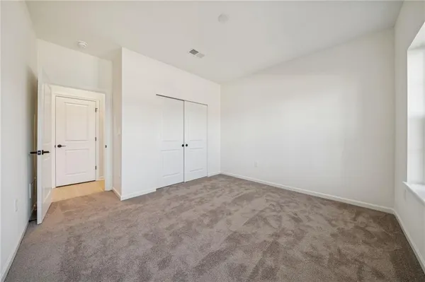 a view of a hallway with closet and wooden floor