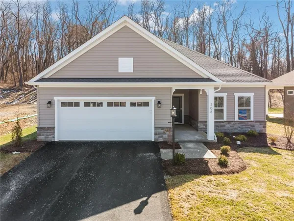 a view of a house with a yard and garage
