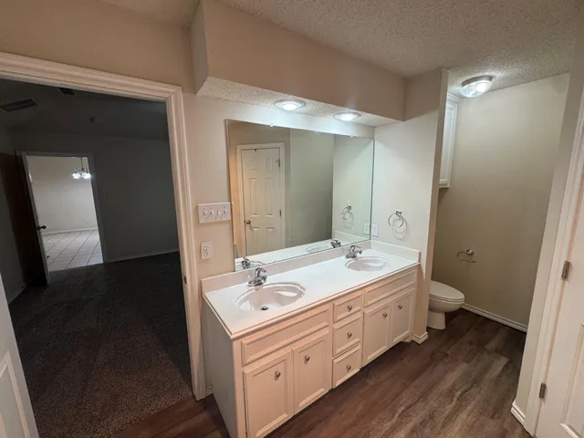 a bathroom with a double vanity sink and mirror